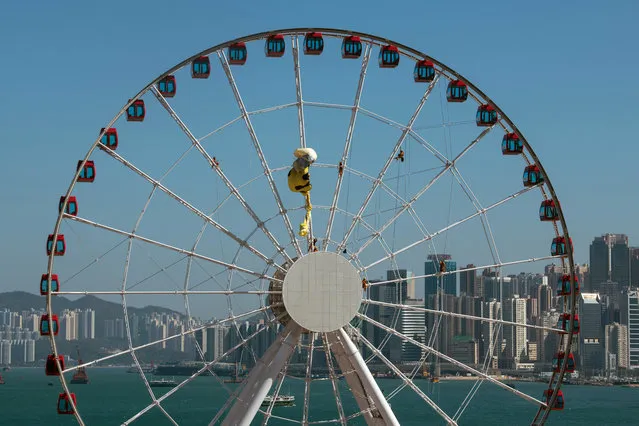Greenpeace activists climb on a ferris wheel in an attempt to unfurl a banner Central, Hong Kong, China, 21 December 2017. A dozen members of Greenpeace climbed onto the wheel to urge Hong Kong people to reduce single-use plastic. However the banner was torn and kept flapping in the wind while the activists remained on the wheel. (Photo by Jerome Favre/EPA/EFE)