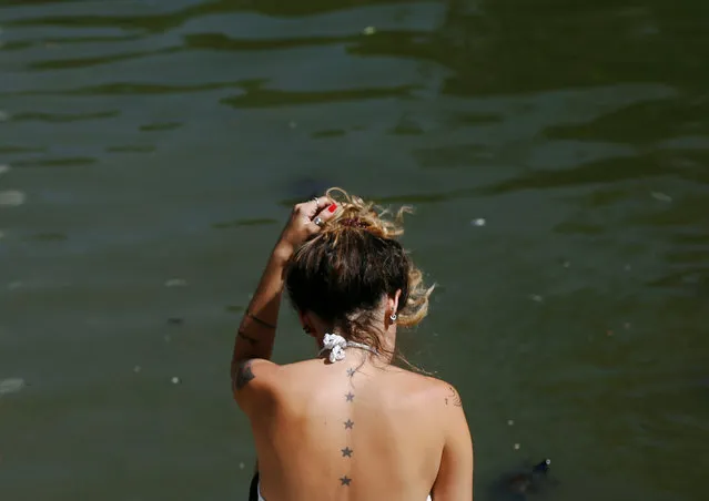 A woman sits at the Retiro park lake as temperatures soar throughout the country in Madrid, Spain September 6, 2016. (Photo by Javier Barbancho/Reuters)