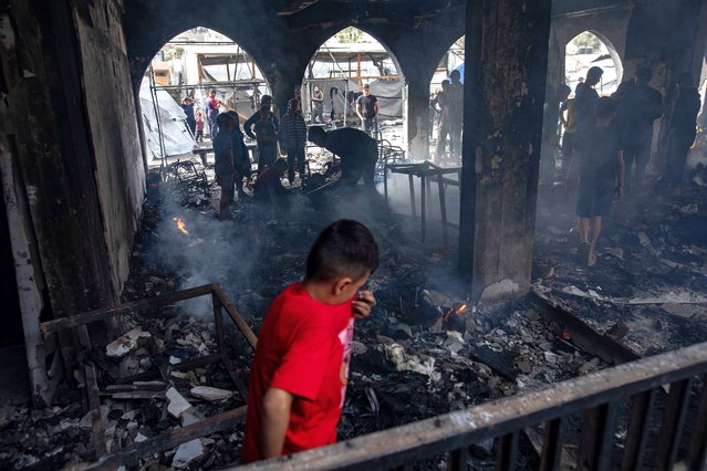 Displaced Palestinians inspect the damage to the Yaffa School following an Israeli airstrike, east of Gaza City, 23 April 2025. (Photo by Haitham Imad/EPA/EFE)