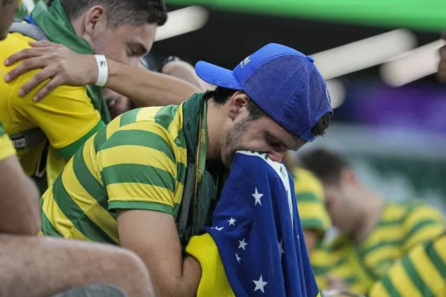 Brazilian fans react on the tribune after losing the World Cup quarterfinal soccer match between Croatia and Brazil, at the Education City Stadium in Al Rayyan, Qatar, Friday, December 9, 2022. (Photo by Martin Meissner/AP Photo)