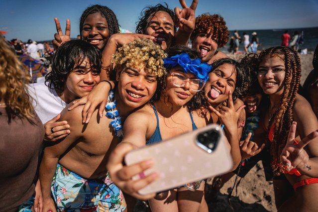A group of kids pose for a selfie on Memorial Day at Coney Island Beach in the Brooklyn borough of New York City on May 26, 2025. (Photo by Angelina Katsanis/Reuters)