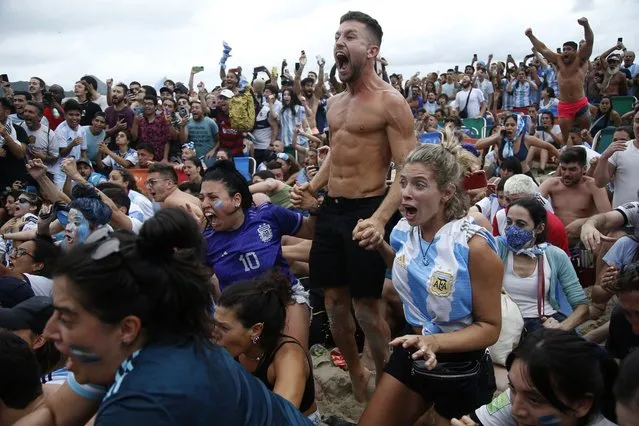 Argentina's fans celebrate the victory of the Argentine national team in a soccer match against France for the World Cup final, in Qatar, on Copacabana beach, in Rio de Janeiro, Brazil, Sunday, December 18, 2022. (Photo by Bruna Prado/AP Photo)