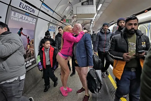 Participants kiss on a platform as they take part in the annual event “No Trousers Tube Ride” in London, Sunday, January 8, 2023. The No Trousers Tube Ride returns to London, the first time the event had taken place since January 2020, due to Covid. (Photo by Kin Cheung/AP Photo) 