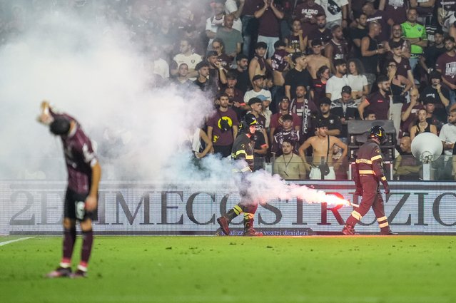 Firemen collect torches throwed by supporters to the pitch during the Serie B Play-Out leg 2 match between US Salernitana and UC Sampdoria at Stadio Arechi on June 22, 2025 in Salerno, Italy. (Photo by Giuseppe Maffia/NurPhoto/Rex Features/Shutterstock)
