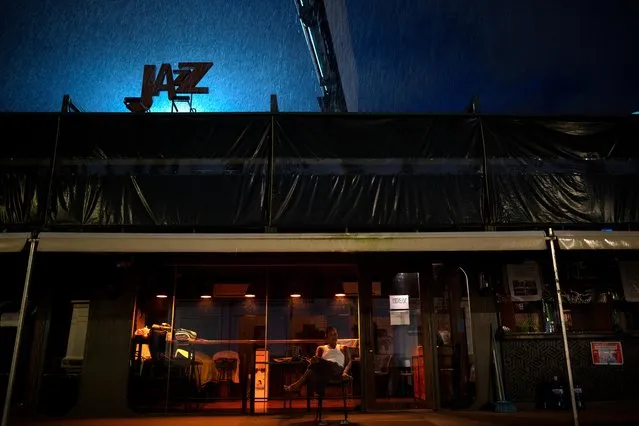 A man sits in front of a temporarily closed bar near a night market amid the outbreak of the coronavirus disease (COVID-19), in Yangon, Myanmar on September 28, 2020. (Photo by Shwe Paw Mya/Reuters)