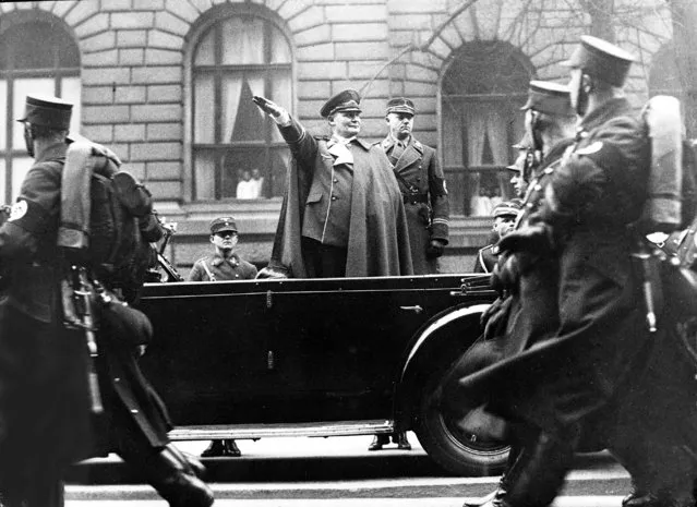 German Air Minister, General Hermann Goering, salutes stormtroopers during the march pass at the Air Ministry, Berlin, January 12, 1937. Goering was also celebrating his forty fourth birthday. Behind Goering, right, is Chief of Staff of the S.A. Victor Lutze. (Photo by AP Photo)