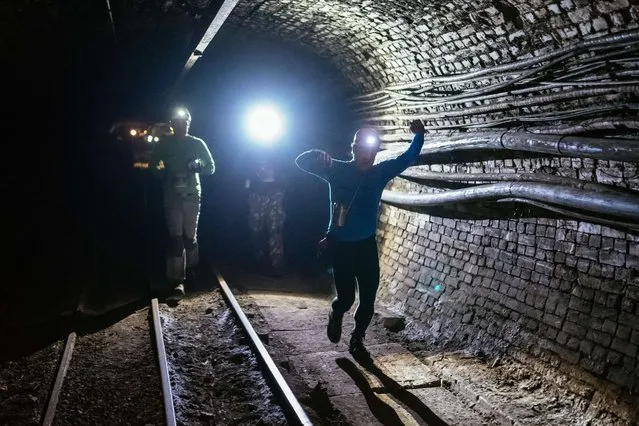 Competitors react as they run during the “Jamatlon Winter Edition” event in Hrastnik on December 6, 2014. Jamatlon (“Jama” meaning cave combined with “tlon” to add a marathon ending to the word) is a 5kms long run containing obstacles related to mining and it takes place in a mine shaft connecting the two Slovenian mining towns of Trbovlje and Hrastnik. (Photo by Jure Makovec/AFP Photo)