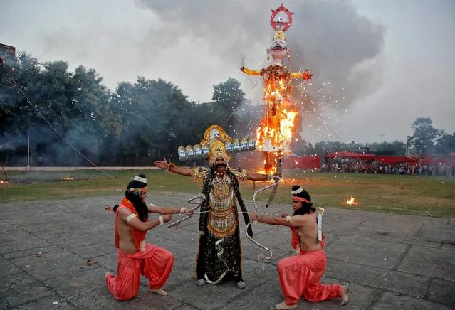 Artists dressed as Hindu lord Rama (L), his brother Laxman (R), and demon King Ravana act in a religious play during Vijaya Dashmi or Dussehra festival celebrations in Chandigarh, India October 11, 2016. (Photo by Ajay Verma/Reuters)