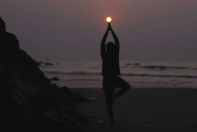 A man performs yoga early morning on the beach along the Bay of Bengal coast in Visakhapatnam, Andhra Pradesh state, India, Saturday, March 4, 2023. (Photo by Mahesh Kumar A./AP Photo)
