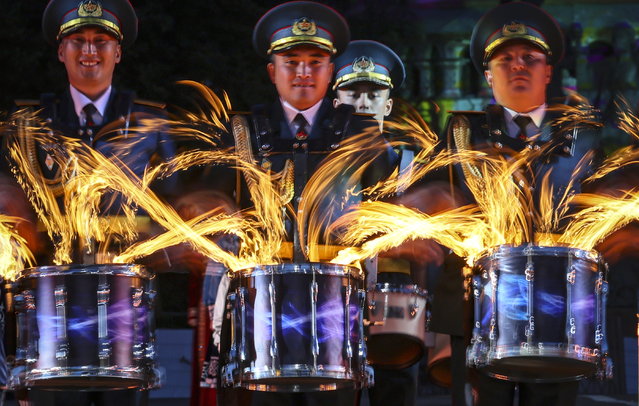 Members of the Central Military Band and the Central Ensemble of the National Military and Patriotic Center of the Kazakhstan Armed Forces perform during the opening of the International Military Music Festival “Spasskaya Tower” on the Red Square in Moscow, Russia, 21 August 2025. The festival runs from 21 to 31 August 2025. (Photo by Yuri Kochetkov/EPA)