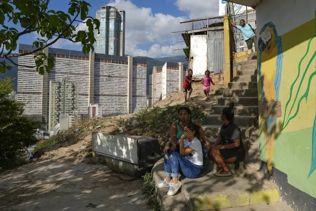 Residents gather outside their home in the San Agustin neighborhood of Caracas, Venezuela, Thursday, March 2, 2023. About three-quarters of Venezuelans live on less than $1.90 a day – the international benchmark of extreme poverty. (Photo by Ariana Cubillos/AP Photo)