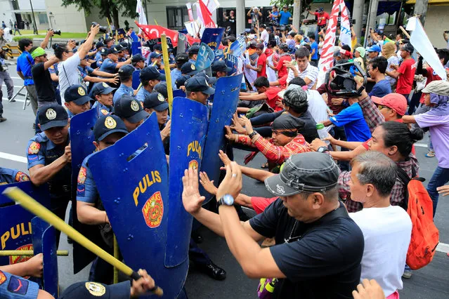 Various activist and Indigenous People's (IP) groups clash with anti-riot policemen during a protest against the continuing presence of U.S. troops in the Philippines in front of the U.S. Embassy in metro Manila, Philippines October 19, 2016. (Photo by Romeo Ranoco/Reuters)