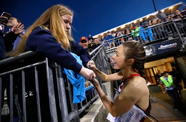 Jenny Simpson signs an autograph for a fan as she leaves the track after winning the women's special 2-mile run at the Drake Relays athletics meet Friday, April 27, 2018, in Des Moines, Iowa. (Photo by Charlie Neibergall/AP Photo)