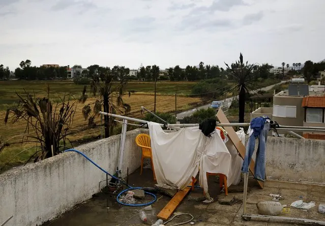 A makeshift shower cabin and toilet are seen atop a deserted hotel, where hundreds of migrants found temporary shelter on the Greek island of Kos, Greece, May 27, 2015. (Photo by Yannis Behrakis/Reuters)