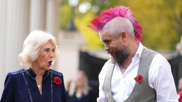 Queen Camilla talks to Spudman as she hosts members of the National Association of Care Catering (NACC), and representatives from Royal Voluntary Service (RVS) in a celebration of community volunteering during Meals on Wheels Week, at Clarence House in central London, England, Wednesday, November 5, 2025.(Photo by Jordan Pettitt/PA Wire via AP Photo)