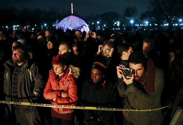 A crowd watches as an interactive art installation created by artist Michael Verdon called the “Temple of Essence” and dedicated to victims of the "war on drugs" is burned on the U.S. National Mall in Washington November 22, 2015. (Photo by Jim Bourg/Reuters)