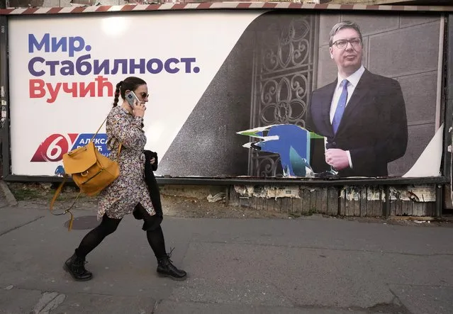 A woman walks by the pre-election billboard showing Current Serbian President and the Serbian Progressive Party leader Aleksandar Vucic in Belgrade, Serbia, Monday, March 28, 2022. Serbia's populist President Aleksandar Vucic, who has fostered close ties with Russia and refused to impose sanctions against Moscow over its invasion of Ukraine, is expected to extend his almost 10-year grip on power in the Balkan country at an election on Sunday. (Photo by Darko Vojinovic/AP Photo)