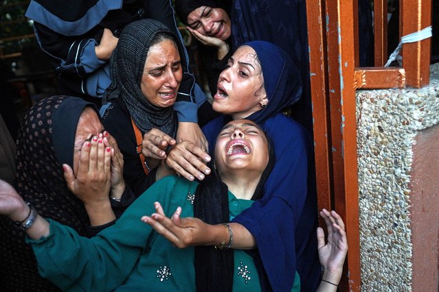 Palestinian women cry as killed members of the Abu Taha family are brought for burial, outside Nasser hospital in Khan Yunis following Israeli bombardment east of the city in the southern Gaza Strip on July 22, 2024, amid the ongoing conflict between Israel and the Palestinian Hamas militant group. (Photo by Bashar Taleb/AFP Photo)