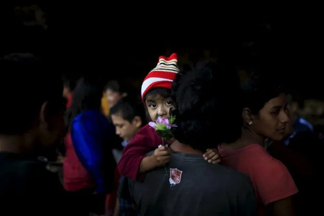 Catholic devotees known as "Cumpas" queue up for breakfast in a cave during a pilgrimage in the town of Cuishnahuat, El Salvador November 26, 2015. (Photo by Jose Cabezas/Reuters)