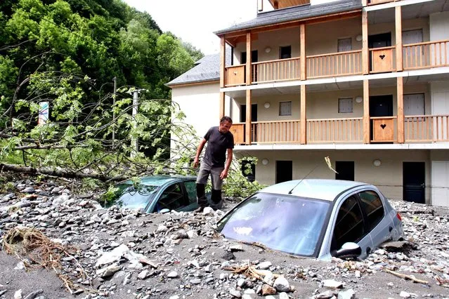 A man looks at the damage caused by mud in the Hautes-Pyrenees, France, on June 20, 2013. (Photo by Laurent Dard/AFP Photo)