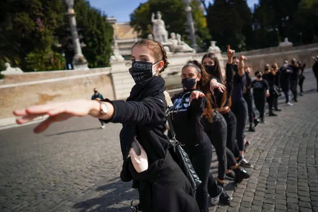 Dancers and theaters workers stage a protest against the government restriction measures to curb the spread of COVID-19, closing gyms, cinemas and movie theaters, in Rome, Thursday, October 29, 2020. (Photo by Andrew Medichini/AP Photo)