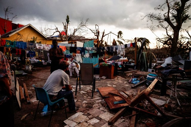 A man sits in the backyard of a house, in the aftermath of Cyclone Chido, in Pamandzi, Mayotte, France, on December 17, 2024. (Photo by Gonzalo Fuentes/Reuters)