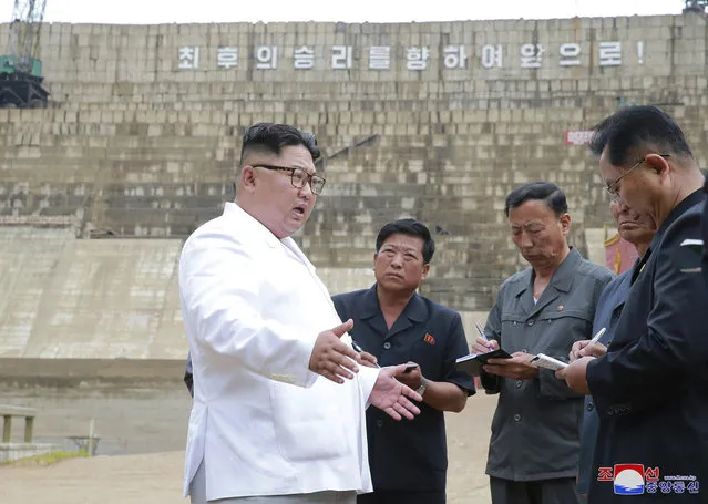 In this undated photo provided on Tuesday, July 17, 2018, by the North Korean government, North Korean leader Kim Jong Un, left, inspects the construction site of a hydroelectric power plant in North Hamgyong Province, North Korea. State media say that Kim has harshly reprimanded local officials over a delayed construction project. The slogan in the background reads: "March toward the final victory!” Independent journalists were not given access to cover the event depicted in this image distributed by the North Korean government. The content of this image is as provided and cannot be independently verified. Korean language watermark on image as provided by source reads: “KCNA” which is the abbreviation for Korean Central News Agency. (Photo by Korean Central News Agency/Korea News Service via AP Photo)