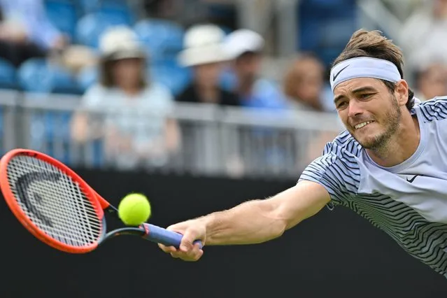 US player Taylor Fritz returns to US player Mackenzie McDonald during their men's singles round of 16 tennis match at the Rothesay Eastbourne International tennis tournament in Eastbourne, southern England, on June 28, 2023. (Photo by Glyn Kirk/AFP Photo)