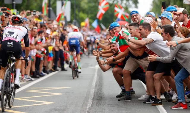 Spectators cheer on Polish rider Rafal Majka of team UAE Team Emirates during the first stage of the Tour de France 2023, a 182km race with start and finish in Bilbao, Spain, 01 July 2023. (Photo by Luis Tejido/EPA/EFE)