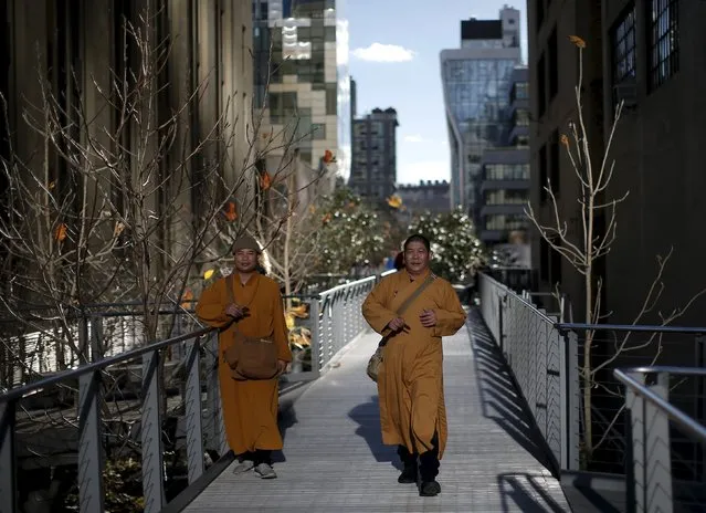 Two monks enjoy mild temperatures as they stroll along the The High Line park, an elevated section of converted New York Central Railroad spur called the West Side Line on Manhattan's West Side Tuesday afternoon in New York City, December 15, 2015. (Photo by Mike Segar/Reuters)