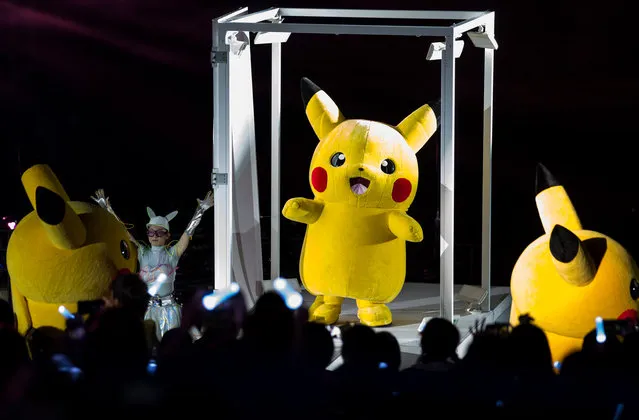 Performers dressed as Pikachu, a character from Pokemon series game titles, dance during the Pikachu Outbreak event hosted by The Pokemon Co. at night on August 10, 2018 in Yokohama, Kanagawa, Japan. (Photo by Tomohiro Ohsumi/Getty Images)