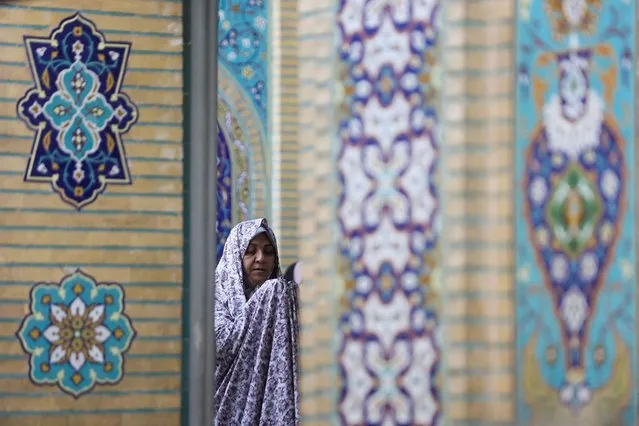 An Iranian woman prays on Eid al-Adha at the shrine of Abdol-Azim in Tehran, Iran on June 29, 2023. (Photo by Majid Asgaripour/WANA (West Asia News Agency) via Reuters)
