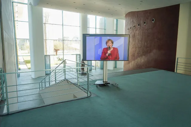 German Chancellor Angela Merkel is displayed on a screen as she attends the digital dialogue series “in conversation with the German Chancellor” at the Chancellery in Berlin, Germany, on April 27, 2021. (Photo by Carstensen Jörg/Pool via AFP Photo)