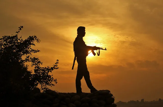 A policeman stands guard outside a police post near Jammu, November 29, 2016. (Photo by Mukesh Gupta/Reuters)