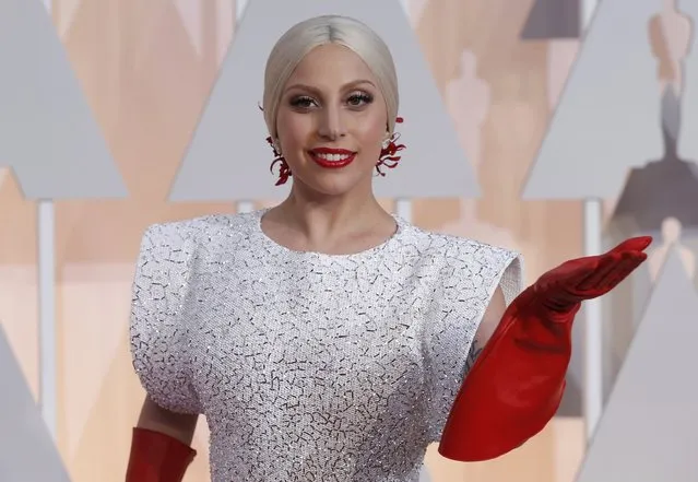 Singer Lady Gaga wears three custom-made Azzedine Alaia pieces and a white embellished gown with long red gloves as she arrives at the 87th Academy Awards in Hollywood, California February 22, 2015. (Photo by Mario Anzuoni/Reuters)