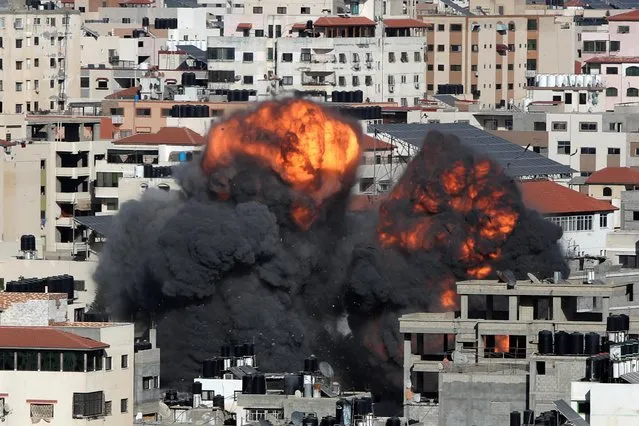Smoke and flames rise during an Israeli air strike, amid a flare-up of Israeli-Palestinian violence, in Gaza City on May 14, 2021. (Photo by Mohammed Salem/Reuters)