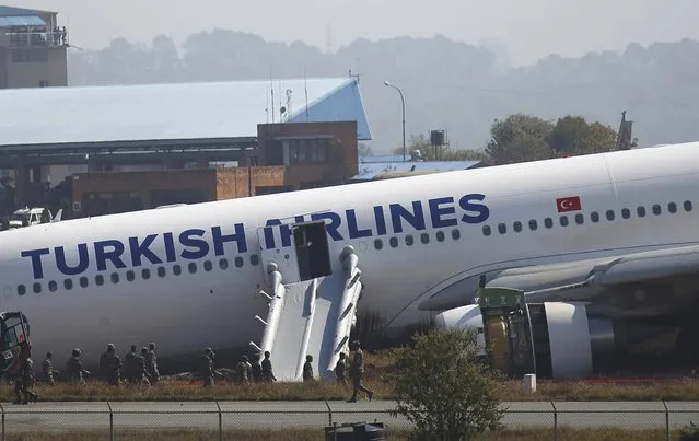 A Turkish Airlines plane lies on the field after it overshot the runway at Tribhuvan International Airport in Kathmandu March 4, 2015. According to local media, all passengers were rescued. REUTERS/Navesh Chitrakar 