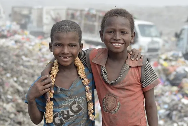 Boys pose for a picture at a rubbish dump, where they are collecting recyclable waste, outside Yemen's Red Sea port city of Houdieda January 20, 2016. (Photo by Abduljabbar Zeyad/Reuters)