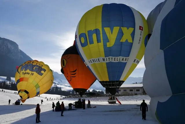 Balloonists prepare to take off during the 38th International Hot Air Balloon Week in Chateau-d'Oex, Switzerland January 23, 2016. (Photo by Denis Balibouse/Reuters)