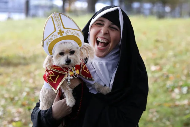 Susan Godwin and her dog Tasha pose for a photo at the 28th Annual Tompkins Square Halloween Dog Parade in New York, October 28, 2018. (Photo by Kevin Coombs/Reuters)