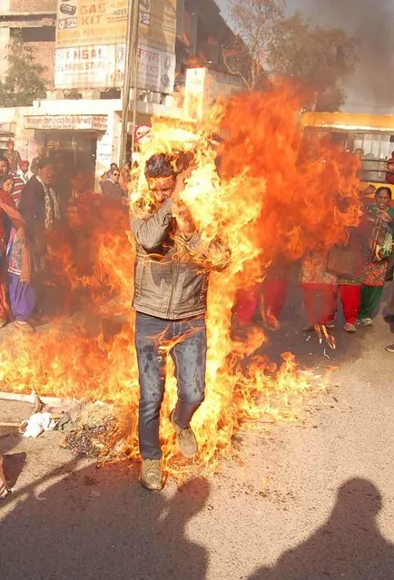 A protester caught on accidental fire during burning of the effigy of Punjab government by contractual teachers appointed under education guarantee scheme at Fauji Chowk, on December 21, 2016 in Bathinda, Punjab, India. (Photo by Ajay Verma/Barcroft Images)
