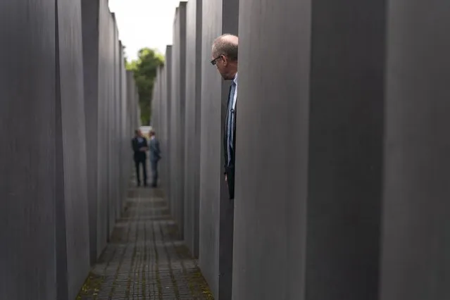 A member of security stands guard as Secretary of State Antony Blinken and German Minister of Foreign Affairs Heiko Maas, background, speak together as they walk through the Memorial to the Murdered Jews of Europe following a ceremony for the launch of a U.S.-Germany Dialogue on Holocaust Issues in Berlin, Thursday, June 24, 2021. Blinken is on a week long trip in Europe traveling to Germany, France and Italy. (Photo by Andrew Harnik/AP Photo/Pool)
