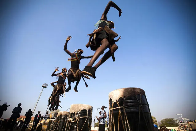 Dancers of the local band Orupaap perform at the Juba Stadium, as part of the closing ceremony of the National Unity Day events in Juba, South Sudan, on January 23, 2016. The soccer tournament brought together 700 young participants from across the country and finalised with the final match between Bentiu and Wau. The National Unity Day was organised by the South Sudan Ministry of Culture, Youth and Sport and the Japan International Cooperation Agency (JICA), with the support of UNESCO, under the slogan “sport for peace and unity” to “promote peace, tolerance and understanding by bringing people together across boundaries, cultures and religions”. (Photo by Albert Gonzalez Farran/AFP Photo)