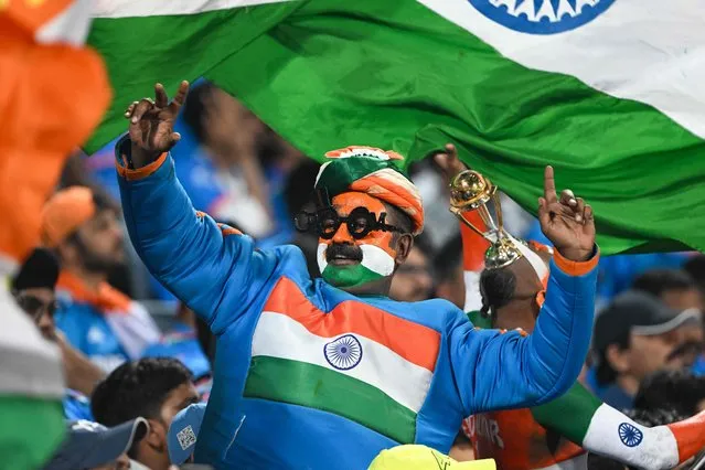 An Indian fan cheers during the 2023 ICC Men's Cricket World Cup one-day international (ODI) match between India and Bangladesh at the Maharashtra Cricket Association Stadium in Pune on October 19, 2023. (Photo by Punit Paranjpe/AFP Photo)