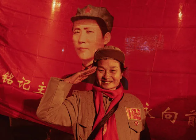A woman salutes as people gather to celebrate China's late chairman Mao Zedong's 123rd birth anniversary in Shaoshan, Hunan province, December 25, 2016. (Photo by Reuters/Stringer)