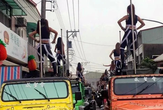Pole dancers perform on top of a jeeps during a funeral procession in south-western Taiwan, on January 4, 2017. More than 50 pole dancers standing on Jeeps brought traffic to a standstill when they were asked to perform at the unusual funeral of a recently deceased government official. Tung Hsiang, who died aged 76 at the end of last year, had his casket paraded around his native Chiayi County, in south-western Taiwan, where he worked for over a dozen years in high-ranking government positions. The funeral procession was organised by his son who said his dad would have loved the loud and rather rowdy scenes. (Photo by AsiaWire)