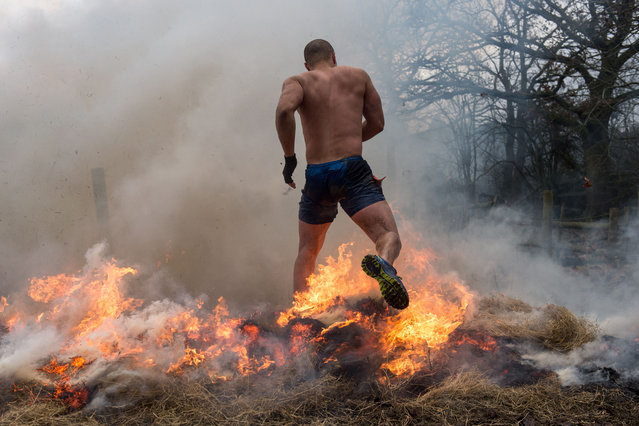 A competitor makes their way through fire as they take part in the Tough Guy endurance event near Wolverhampton, central England, on January 27, 2019. (Photo by Oli Scarff/AFP Photo)