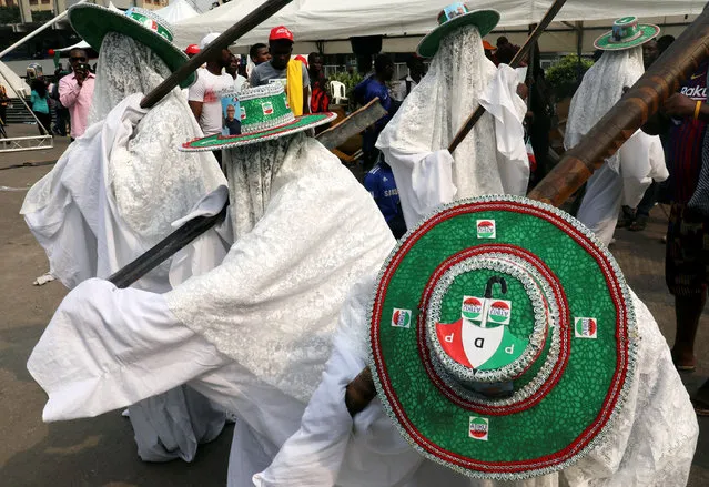 Supporters of the People's Democratic Party (PDP) perform while wearing hats with PDP branding during a campaign rally in Lagos, Nigeria February 12, 2019. Picture taken February 12, 2019. (Photo by Luc Gnago/Reuters)