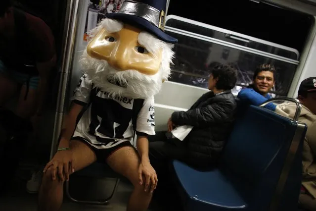 A man without pants and wearing a mask sits in a subway train during the “No Pants Subway Ride” in Mexico City January 12, 2014. (Photo by Tomas Bravo/Reuters)