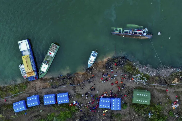 In this photo released by Xinhua News Agency, rescuers conduct search and rescue at the site of an overturned passenger ship in Liupanshui in southwest China's Guizhou province, Sunday, September 19, 2021. The boat has left multiple people dead, with several others still missing, according to state media on Sunday. CCTV said that the ship overturned shortly after it departed Saturday evening. Preliminary investigations suggest that the ship was blown over by strong winds. (Photo by Ou Dongqu/Xinhua via AP Photo)